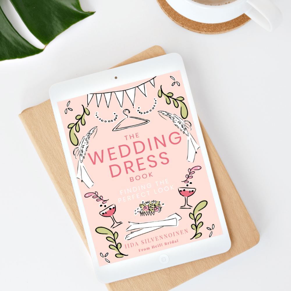 Wedding dress guide book open on an iPad on a minimalist tabletop